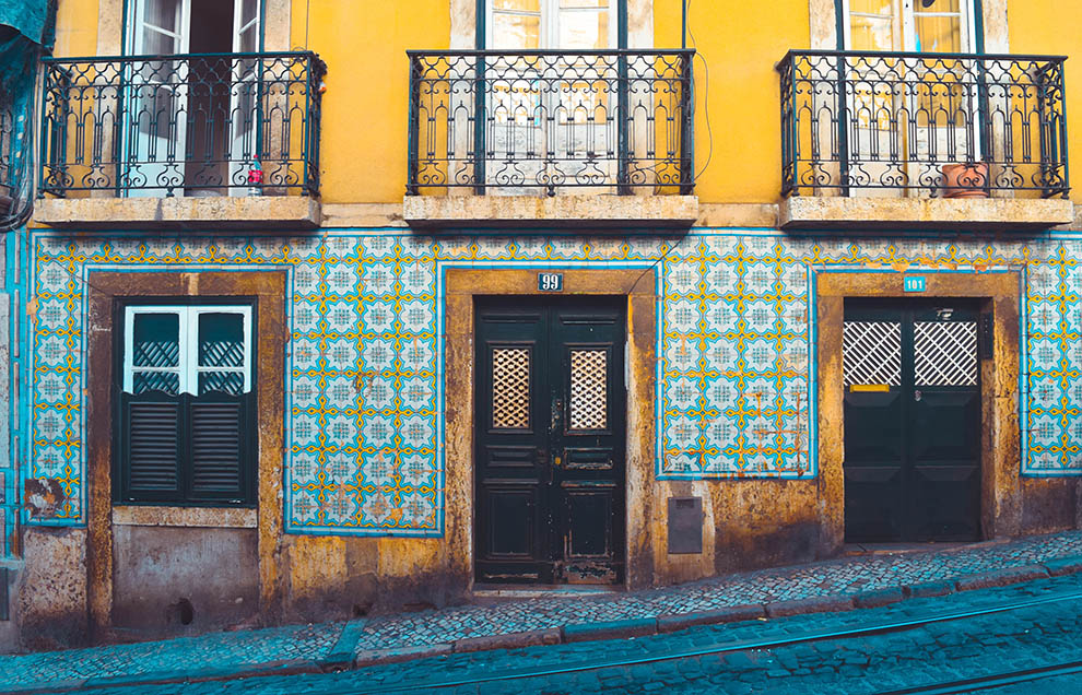 immeuble emblématique de Lisbonne, façade jaune pour les étages, au rez de chaussé façade recouverte de carreaux bleus appelés azulejos